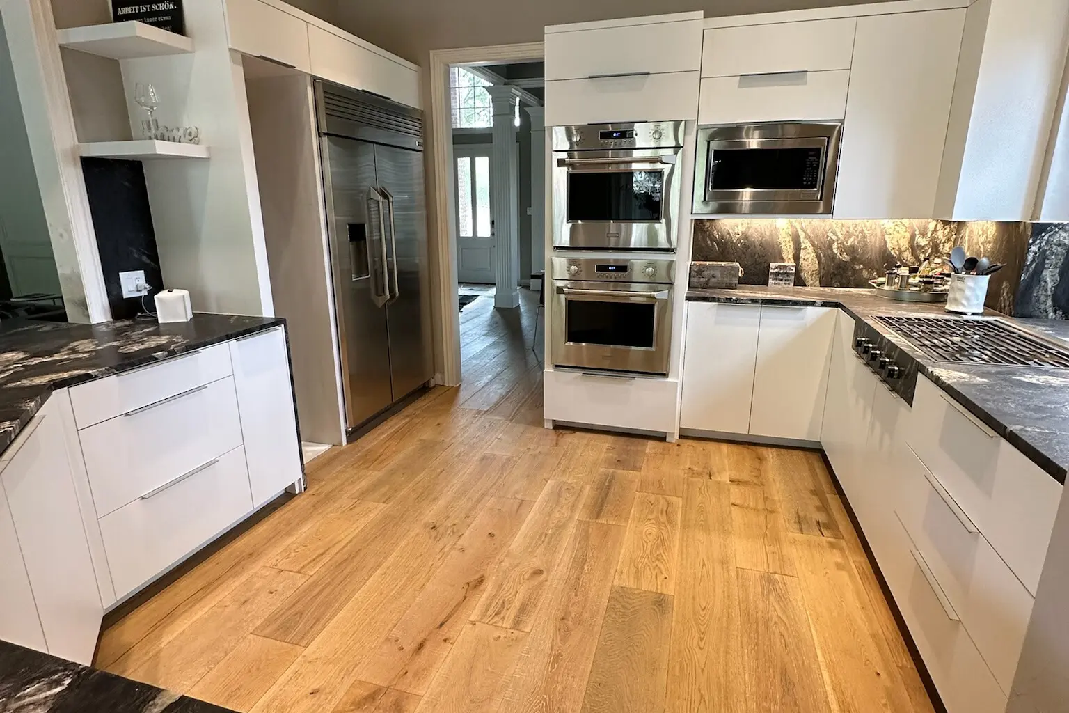 Modern white kitchen renovation showcasing granite countertops and custom cabinetry, representing typical Kitchen Remodel Cost in Plano TX