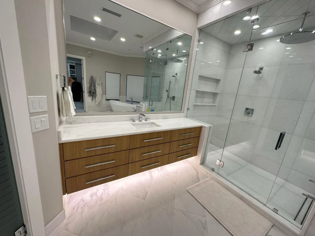 Sleek modern luxury Bathroom Remodeling Dallas TX featuring a frameless glass shower, floating vanity with LED lighting, and marble-style tile flooring