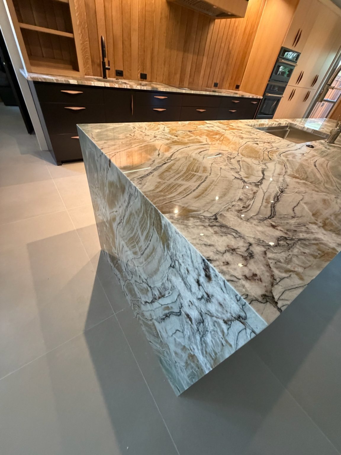 Quartzite waterfall countertop in a West Plano kitchen remodel